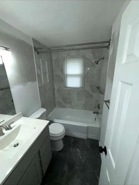 Bathroom remodel with marble tile tub-shower surround and new vanity