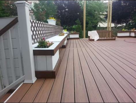 Finished composite deck with built-in planter benches