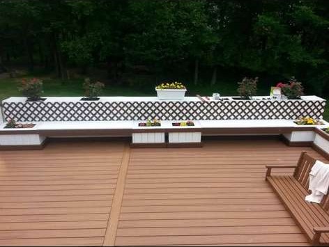 Composite deck with built-in bench seating and lattice privacy rail