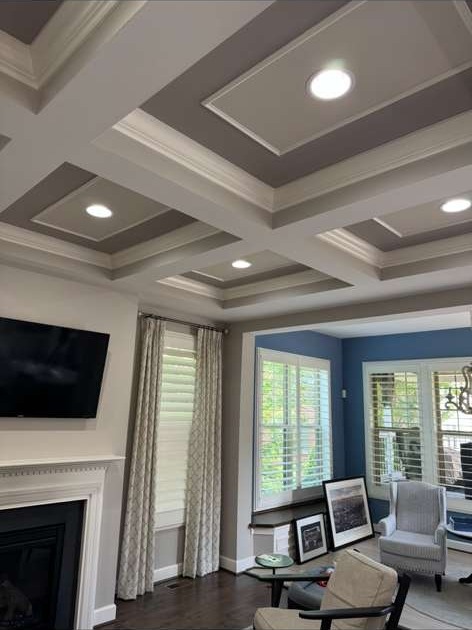 Remodeled living room with coffered ceiling and hardwood floors