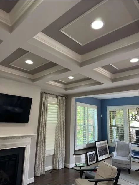 Remodeled living room with coffered ceiling and hardwood floors
