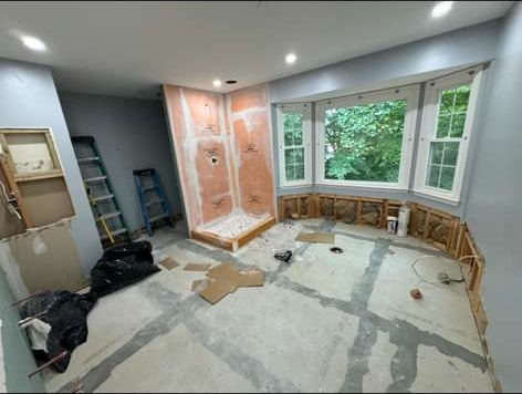 Primary bathroom gutted to the studs during demolition, with bay window