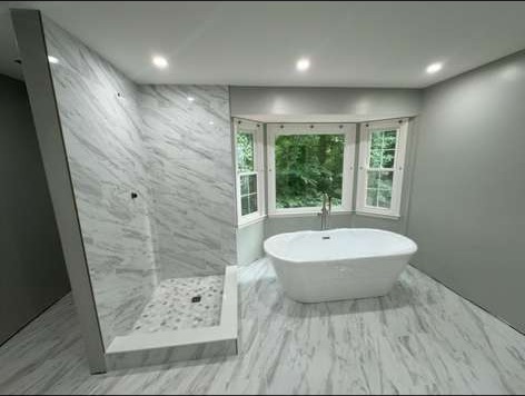 Primary bathroom remodel with freestanding tub and bay window