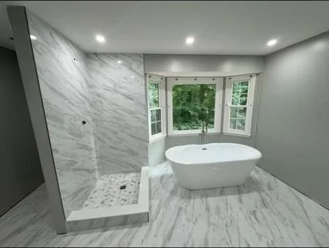 Primary bathroom remodel with freestanding tub and bay window