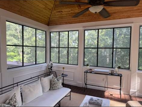 Renovated sunroom with wood plank ceiling and new windows, part of a whole home renovation